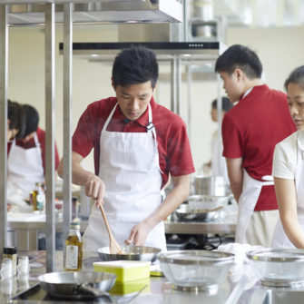 students-preparing-their-dishes-in-the-culinary-lab